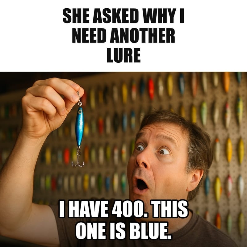 A man holding up a single shiny blue fishing lure with reverent awe in his garage, a wall behind him covered with hundreds of lures on pegboards. Caption: "She asked why I need another lure I have 400. This one is blue."