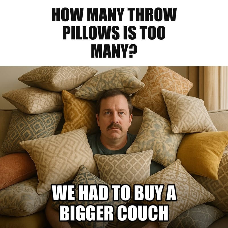A living room couch completely buried under dozens of decorative throw pillows, a husband peeking out from between them, deadpan. Caption: "How many throw pillows is too many? We had to buy a bigger couch"